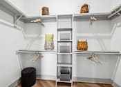 Thumbnail 8 of 34 - A white closet with shelves and hangers.