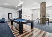 Thumbnail 10 of 24 - A room with a pool table and a striped carpet.