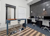 Thumbnail 13 of 24 - A modern office with a wooden floor and white chairs.