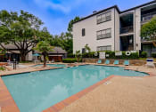 Thumbnail 15 of 32 - the preserve at ballantyne commons pool and building with trees and buildings