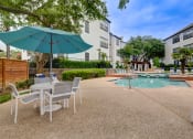 Thumbnail 20 of 32 - our apartments have a pool and patio with chairs and umbrellas