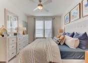 Thumbnail 11 of 16 - a bedroom with a bed and a ceiling fan