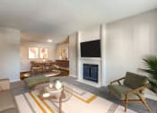 Thumbnail 6 of 20 - a living room with a fireplace and a table and chairs