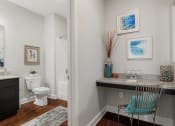 Thumbnail 23 of 29 - a bathroom with a toilet and a sink and a chair