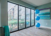 Thumbnail 11 of 29 - an empty living room with large windows and blue balloons