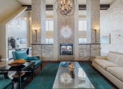 Thumbnail 2 of 29 - a living room with a white couch and a fireplace