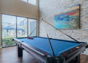 Thumbnail 6 of 29 - a pool table in a living room with a large window