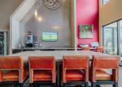 Thumbnail 5 of 29 - a dining room with a table and chairs and a television