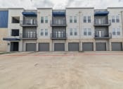 Thumbnail 29 of 29 - an empty parking lot in front of an apartment building