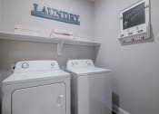 Thumbnail 26 of 29 - a laundry room with two washes and a dryer