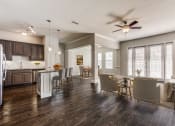 Thumbnail 2 of 42 - a living room with a kitchen and a ceiling fan