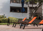 Thumbnail 22 of 32 - a table and chairs with an umbrella on a patio