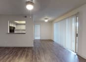Thumbnail 10 of 32 - an empty living room with wood flooring and a large window