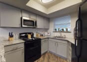 Thumbnail 7 of 32 - a kitchen with white cabinets and black appliances and granite counter tops