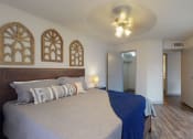 Thumbnail 6 of 32 - a bedroom with a large bed and a ceiling fan