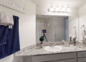 Thumbnail 9 of 32 - a bathroom with a sink and a mirror and a towel rack