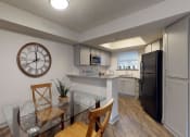 Thumbnail 4 of 32 - an open kitchen and dining room with a large clock on the wall