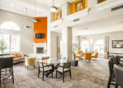Thumbnail 10 of 19 - a large living room with tables and chairs and a fireplace