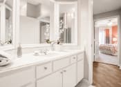 Thumbnail 7 of 19 - a white bathroom with a large mirror and a sink