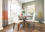 Thumbnail 4 of 19 - a dining room with a table and chairs and a window