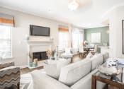 Thumbnail 1 of 19 - a living room with a fireplace and a couch