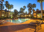 Thumbnail 19 of 19 - a swimming pool at night with palm trees