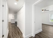 Thumbnail 37 of 42 - a renovated living room and kitchen with white walls and wood flooring