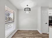 Thumbnail 7 of 38 - A room with a wooden floor and a white door.