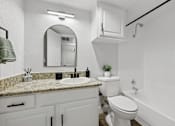 Thumbnail 10 of 38 - A white bathroom with a sink, toilet, and bathtub.