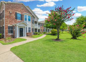 Thumbnail 36 of 39 - an apartment building with a sidewalk in front of it