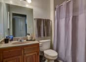 Thumbnail 8 of 8 - a bathroom with a toilet and a sink and a shower