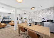 Thumbnail 11 of 15 - A modern kitchen with a wooden table and chairs.
