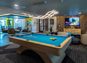 Thumbnail 13 of 25 - a pool table in a room with a tv