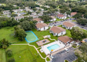 Thumbnail 19 of 20 - an aerial view of a neighborhood with houses and a swimming pool