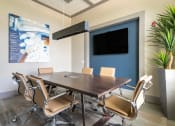 Thumbnail 12 of 23 - a conference room with a table and chairs