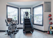 Thumbnail 18 of 39 - A fitness center with a treadmill, exercise balls, and a weight bench.