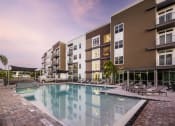 Thumbnail 31 of 45 - a large swimming pool in front of some apartment buildings