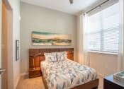 Thumbnail 20 of 45 - a bedroom with a bed and a window