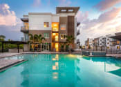Thumbnail 41 of 45 - a large swimming pool in front of a building