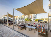 Thumbnail 37 of 45 - a lounge area with tables and chairs on a patio