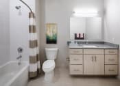 Thumbnail 21 of 45 - a bathroom with a toilet sink and bath tub