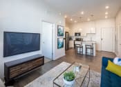 Thumbnail 11 of 45 - a living room with a television and a kitchen