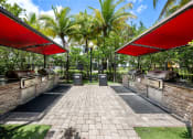 Thumbnail 9 of 44 - a picnic area with barbecue grills and a red roof
