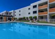 Thumbnail 16 of 22 - a large swimming pool in front of an apartment building