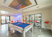 Thumbnail 11 of 35 - A pool table is in the middle of a room with a bar area.