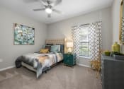Thumbnail 22 of 67 - a bedroom with a bed and a ceiling fan