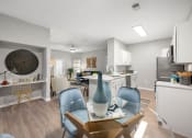 Thumbnail 15 of 67 - an open kitchen and living room with a dining room table and chairs