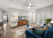 Thumbnail 8 of 67 - a living room with a ceiling fan and a couch
