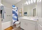 Thumbnail 23 of 67 - a bathroom with a shower toilet and sink and a mirror