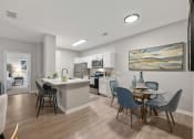 Thumbnail 11 of 67 - an open kitchen and dining area with a table and chairs and a living room